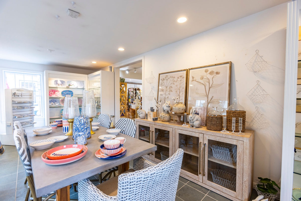 The dining room at the shop, with set tables and a sideboard of serveware